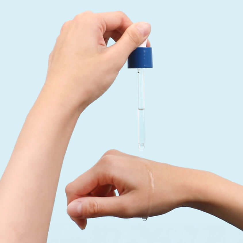 Application of ROUND LAB Birch Moisture Ampoule 50ml on hand with dropper