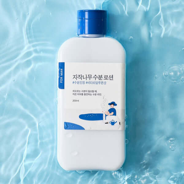 ROUND LAB For Men Birch Moisture Lotion 200ml bottle on a watery background