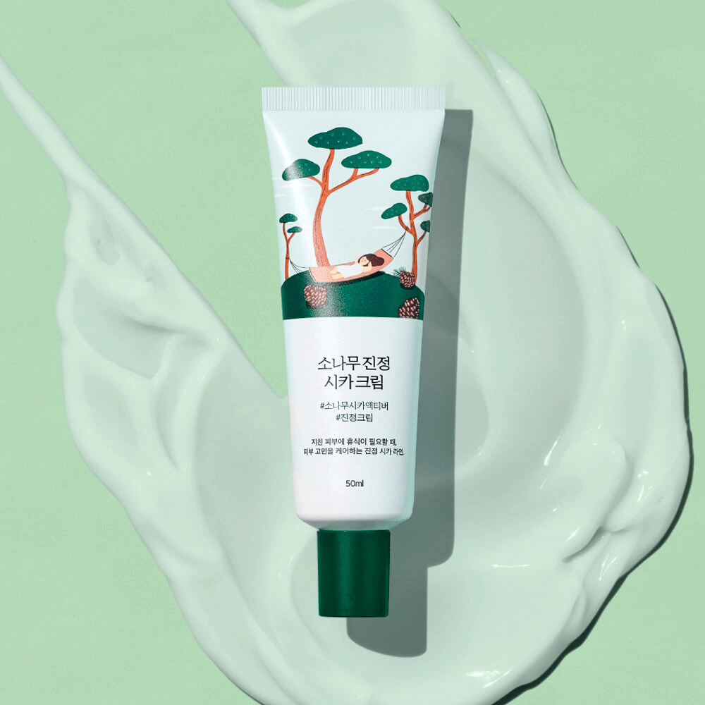 ROUND LAB Pine Calming Cica Cream 50ml tube on a green background with cream swirls