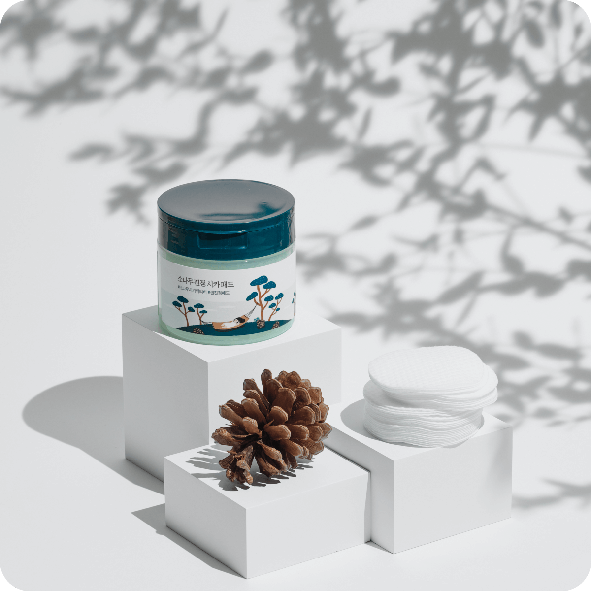 ROUND LAB Pine Calming Cica Pads 50 sheets displayed with pine cone on white blocks for soothing skincare