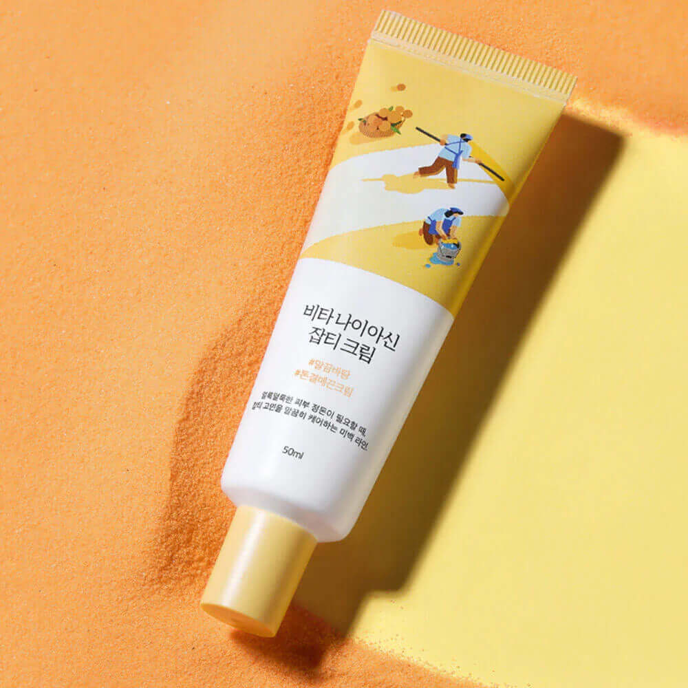 ROUND LAB Vita Niacin Spot Cream 50ml on a sandy background