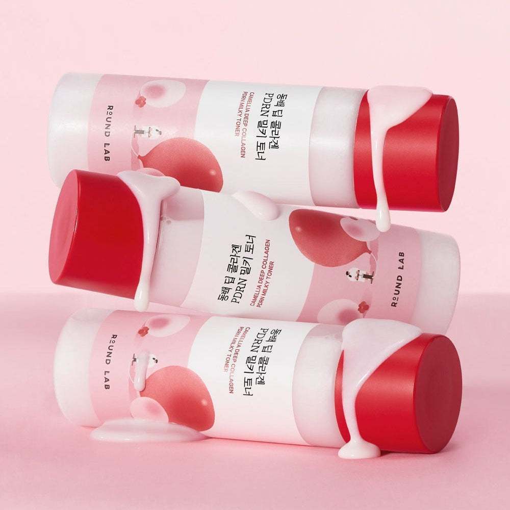 ROUND LAB Dongbaek Deep Collagen PDRN Milky Toner 150ml with red caps and creamy texture on pink background