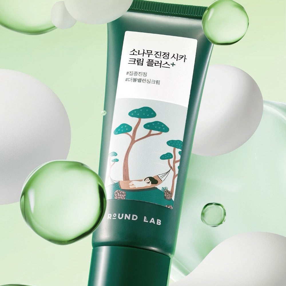 ROUND LAB Pine Calming Cica Cream Plus 60ml tube with green design and floating bubbles, skincare product for soothing and calming skin.