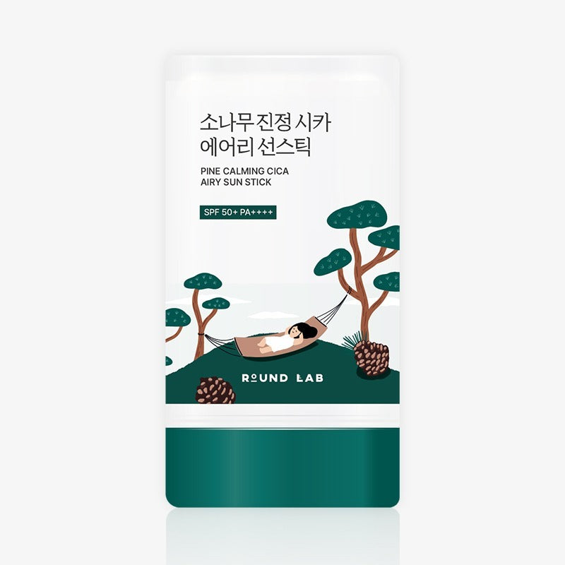Packaging of ROUND LAB Pine Soothing Cica Airy Sun Stick 19g with illustration of a person relaxing in a hammock among pine trees.