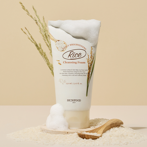 SKINFOOD Rice Daily Brightening Cleansing Foam 150ml product image with foam and rice background.