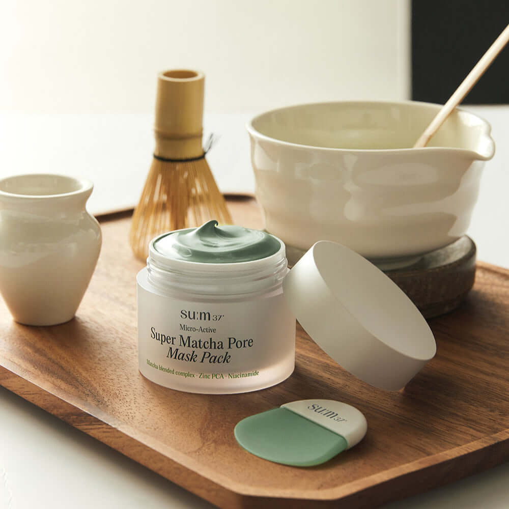 SU:M37 Microactive Super Matcha Pore Mask 100ml displayed on wooden tray with traditional matcha tools.