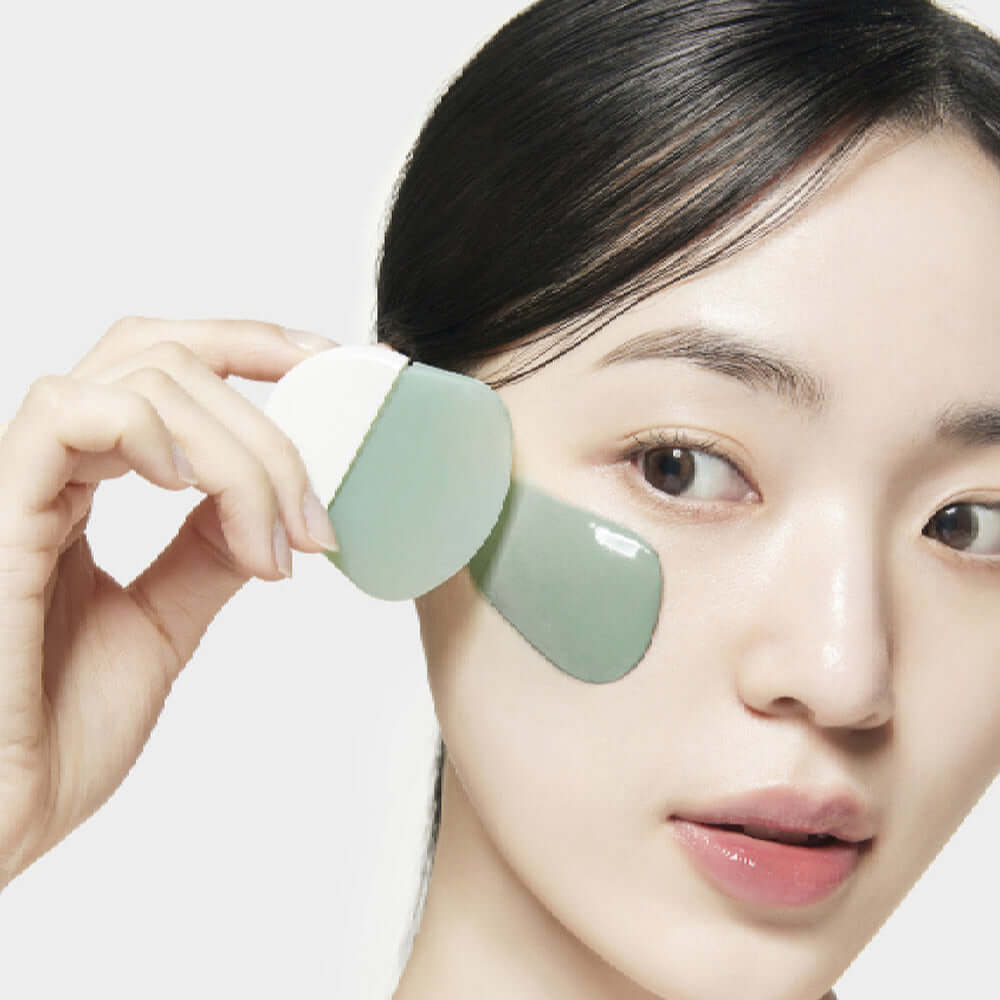 Woman applying SU:M37 Microactive Super Matcha Pore Mask 100ml to her face, demonstrating skincare routine.