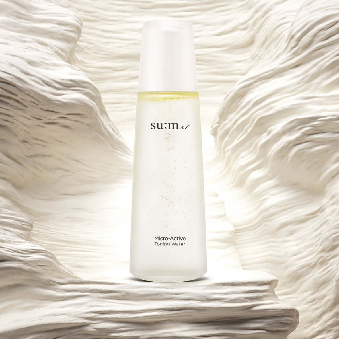 Image of SU:M37 Microactive Toning Water 150ml bottle against a textured background.