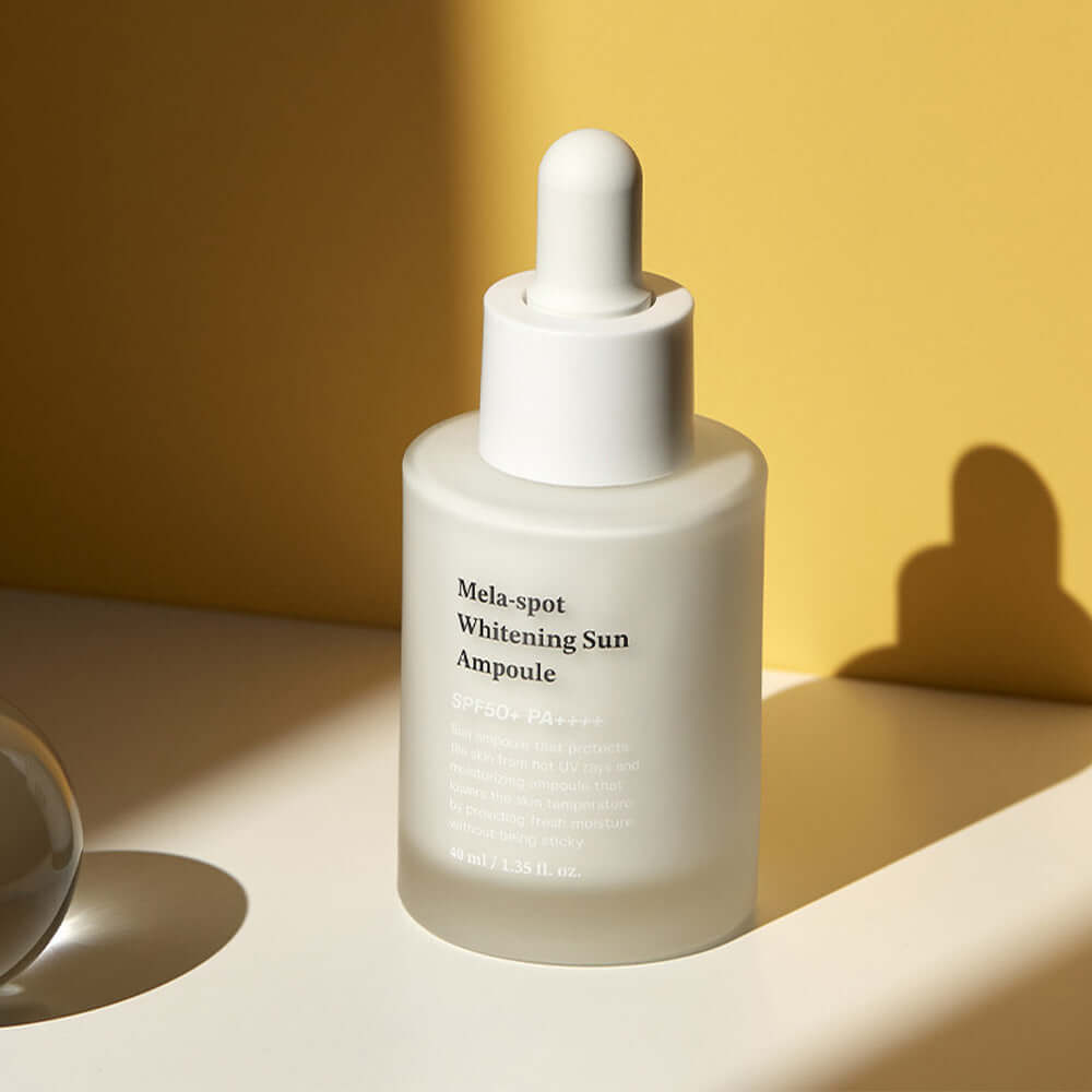 SUNGBOON EDITOR Mela Spot Whitening Sun Ampoule 40ml product bottle against a yellow background for skincare routine enhancement.