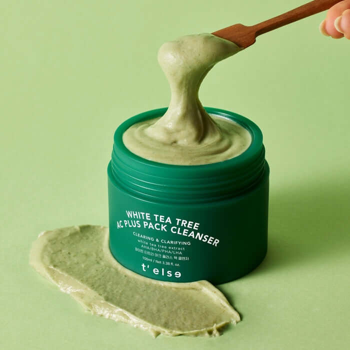 T'ELSE White Tea Tree Arc Plus Pack Cleanser 100ml in a green jar with product being scooped on a spatula, creamy texture visible