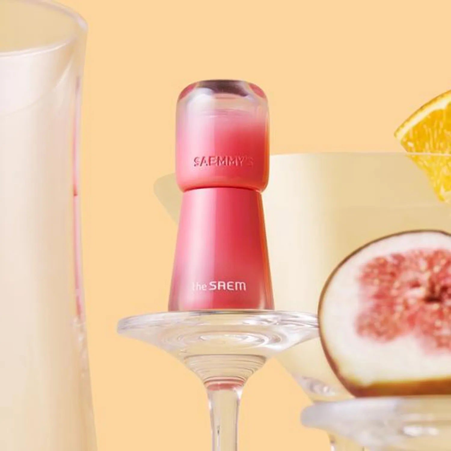 THE SAEM Saemmy's Aid Shot Tint in a vibrant display with fruits and drinks on a pastel background.