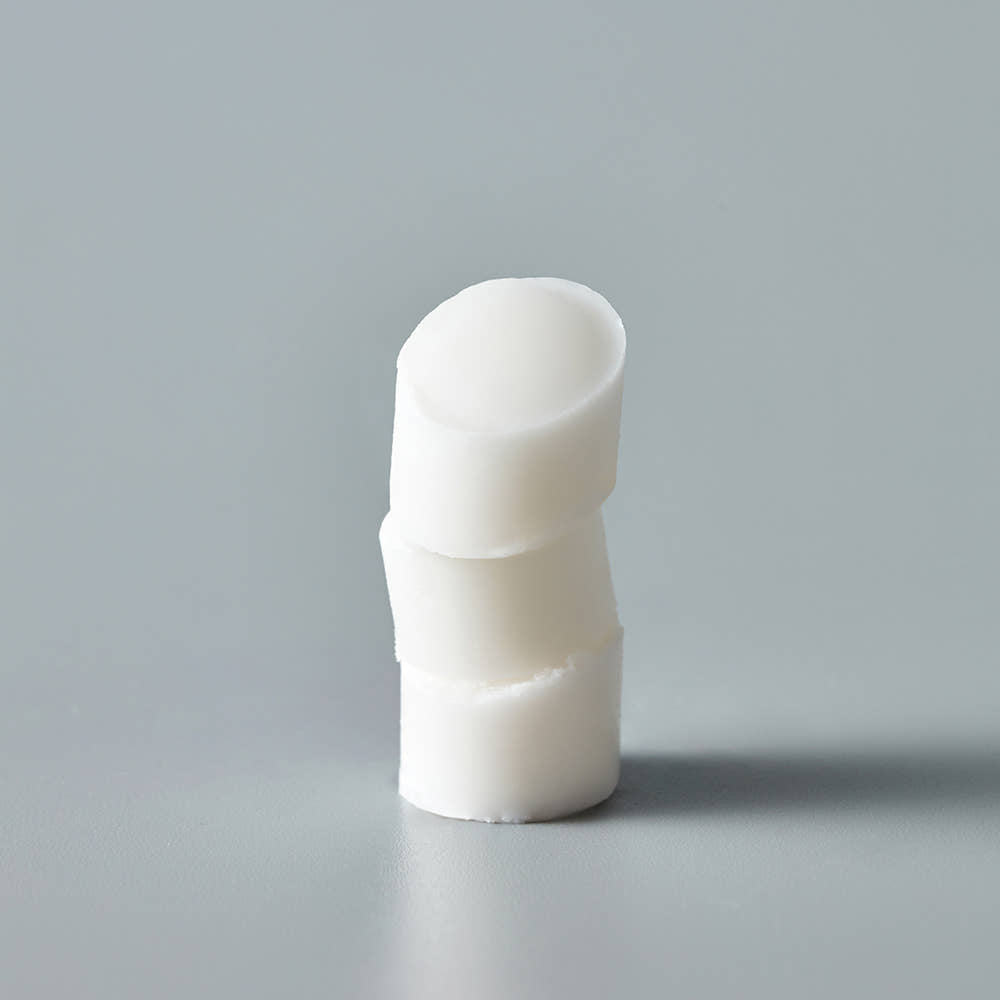 THE SAEM Soft Blurring Primer Lip Balm displayed on a grey background, emphasizing its smooth texture and creamy consistency.