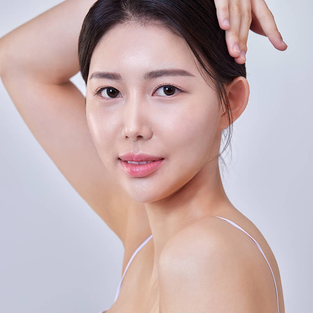 Smiling woman with clear skin showcasing results of THE SAEM Temptation Age Return Toner 130ml.
