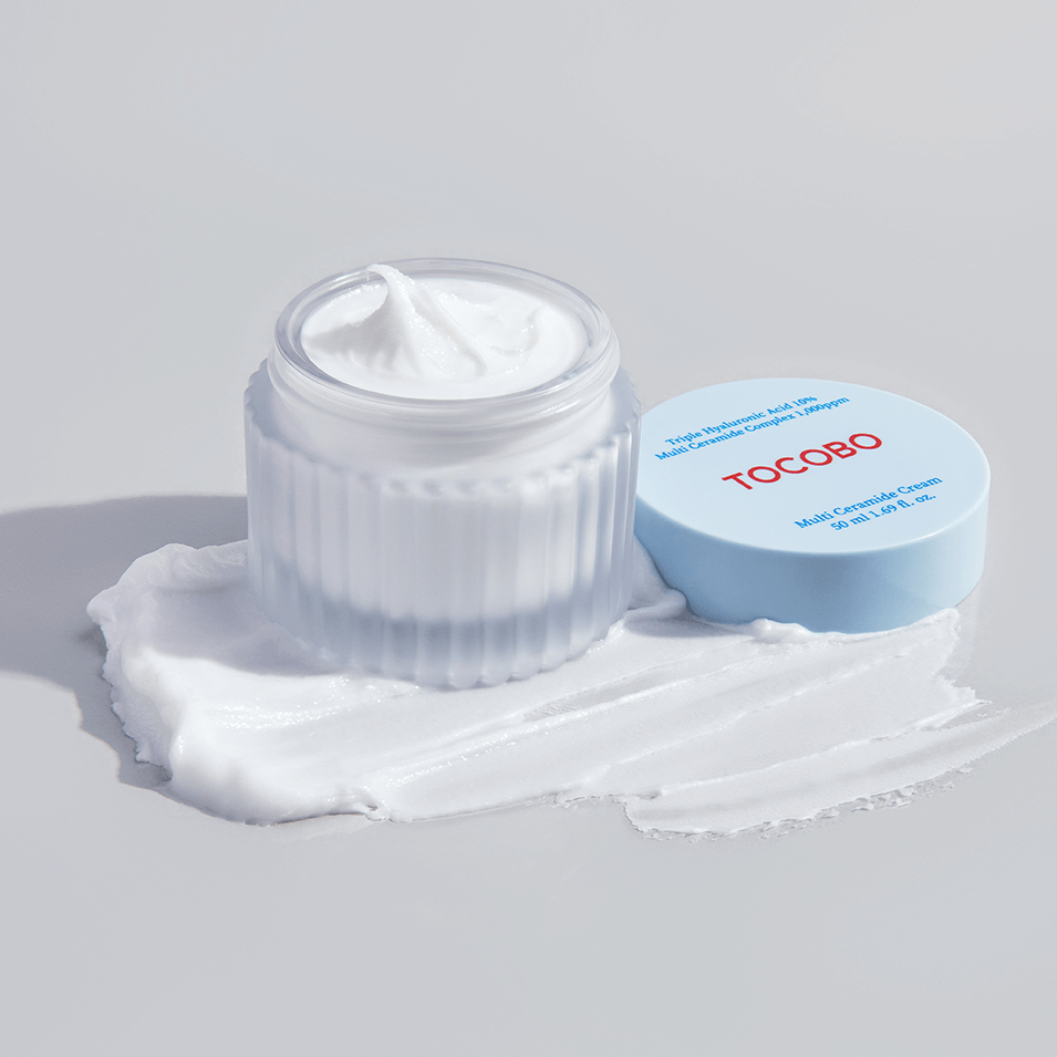 TOCOBO Multi Caramide Cream in open jar with lid on texture smear.