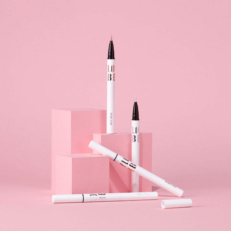 TONY MOLY Aegyo Beam Glitter Liner displayed with pink geometric blocks
