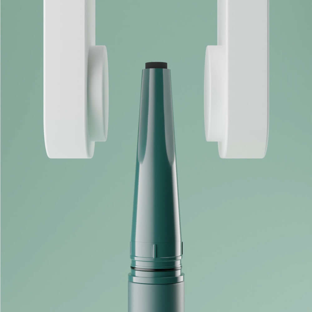 UNLEASHIA Easy Glide Flat Eyeliner against green background, showcasing the product's sleek design and precise tip.