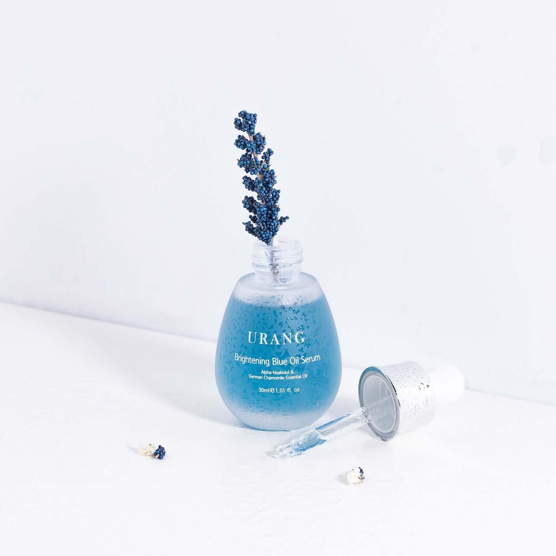 URANG Brightening Blue Oil Serum 30ml bottle with dropper on a white background featuring a lavender sprig.
