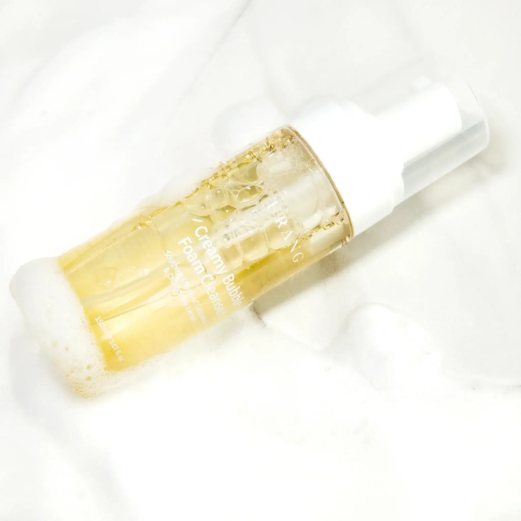 URANG Creamy Bubble Foam Cleanser 150ml bottle on a foamy background, showcasing its gentle and effective cleansing formula.