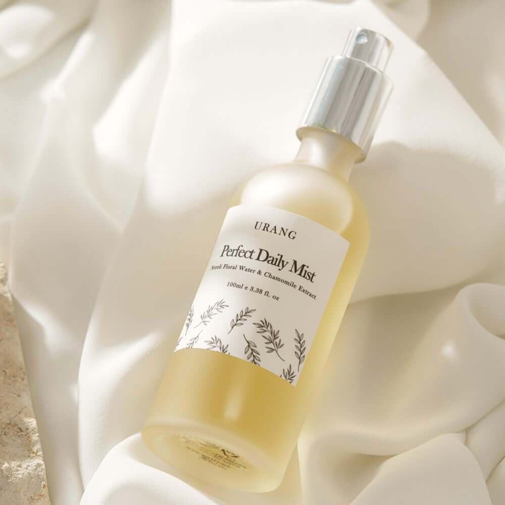URANG Perfect Daily Mist 100ml bottle against a soft fabric background