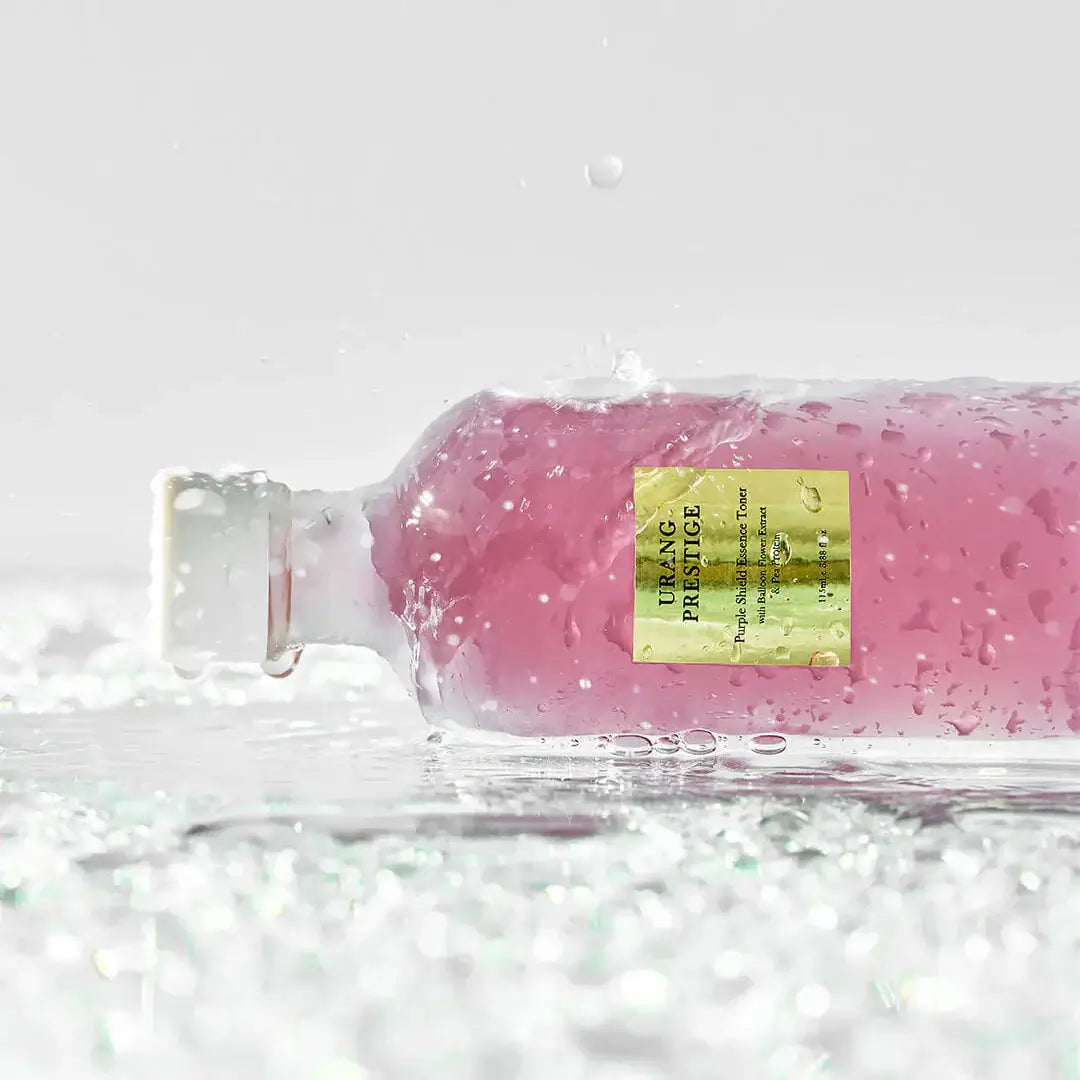 URANG Prestige Purple Shield Essence Toner bottle on wet surface with water droplets