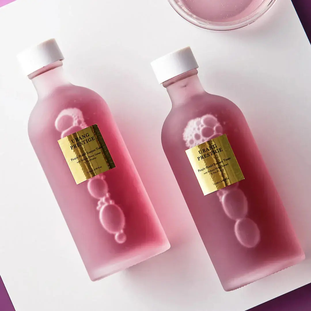 URANG Prestige Purple Shield Essence Toner bottles with golden labels on a white background.