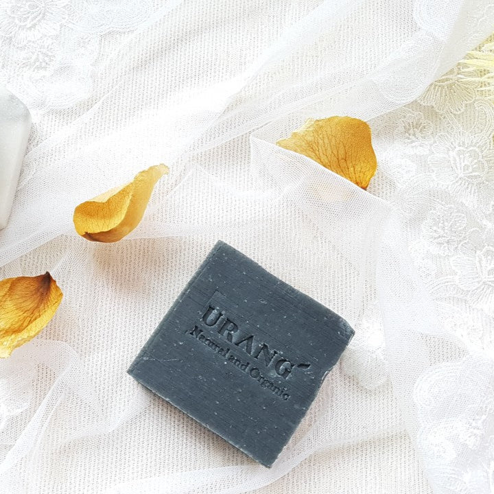 URANG Troubleshooter CP Handmade Soap on lace cloth with rose petals, highlighting natural and organic skincare benefits.