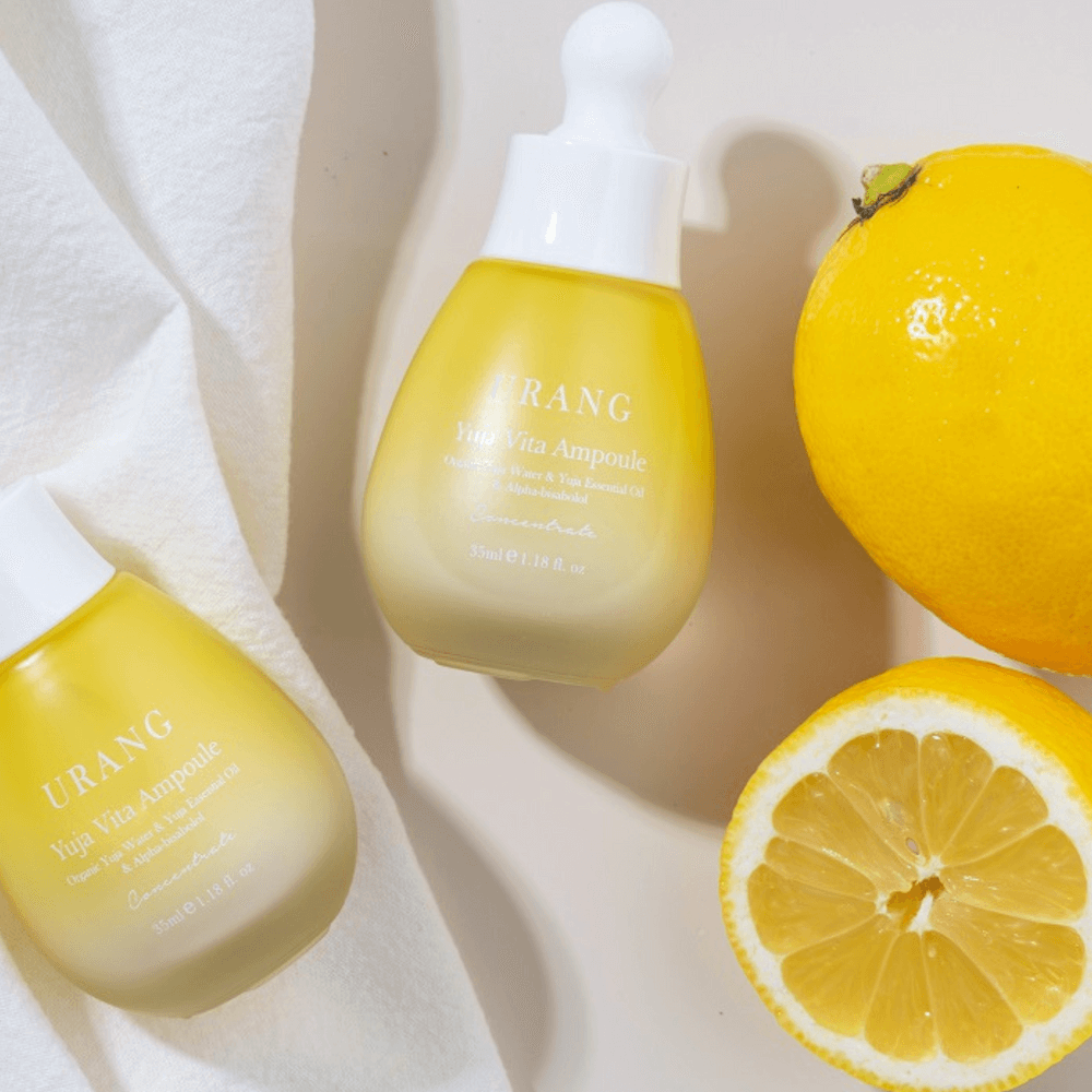 URANG Yuja Vita Ampoule with fresh yuja fruit on white background, highlighting its natural vitamin-rich formula for radiant skin.