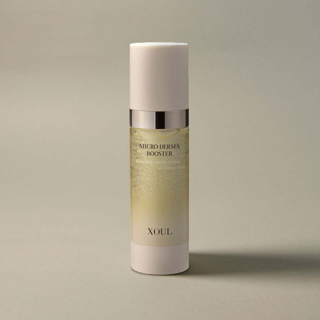XOUL Micro Derma Booster 30ml serum bottle on an elegant neutral background