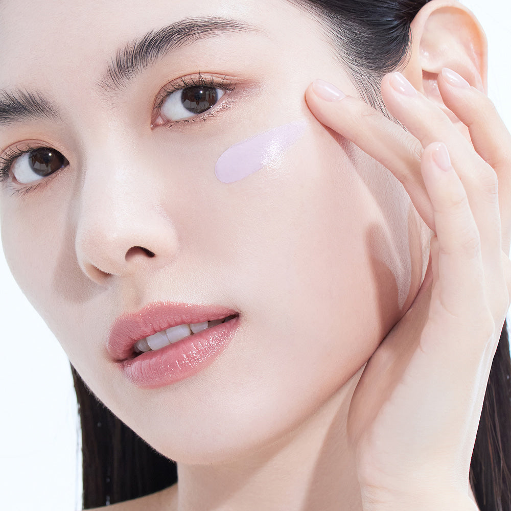 Woman applying AMELI Complement Series Bora Filter 50ml, showcasing smooth skin texture.