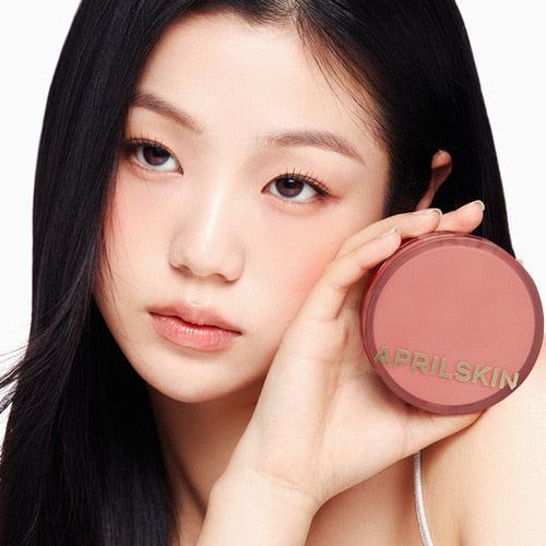 Woman holding APRIL SKIN Hero Cushion compact.
