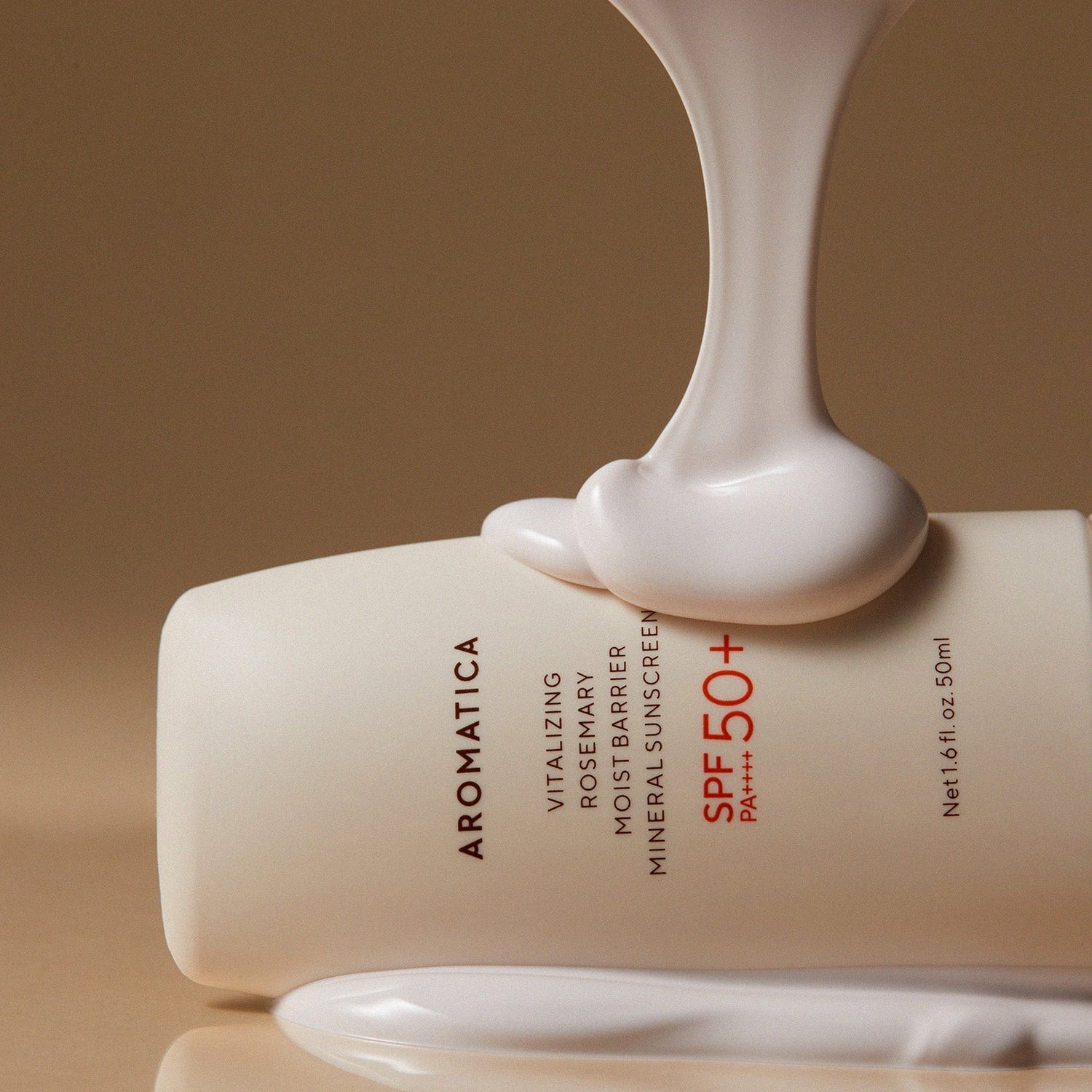 AROMATICA Vitalizing Rosemary Moisture Barrier Sunscreen 50ML tube with cream texture spilling over, SPF 50+ prominently displayed.