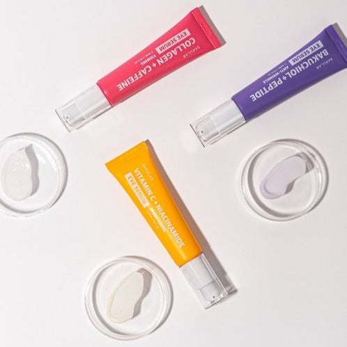 Flat lay of three colorful lip serums including BARULAB Bakuchiol Peptide Smooth Lip Serum 10g arranged with swatches on a light background.