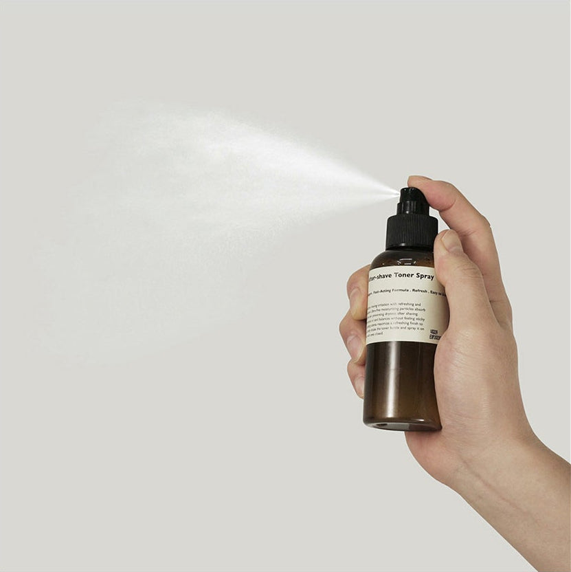 LAZY SOCIETY Cica Aftershave Toner Spray 120ml being sprayed from brown bottle held by hand - Gentleman Korea men’s skincare