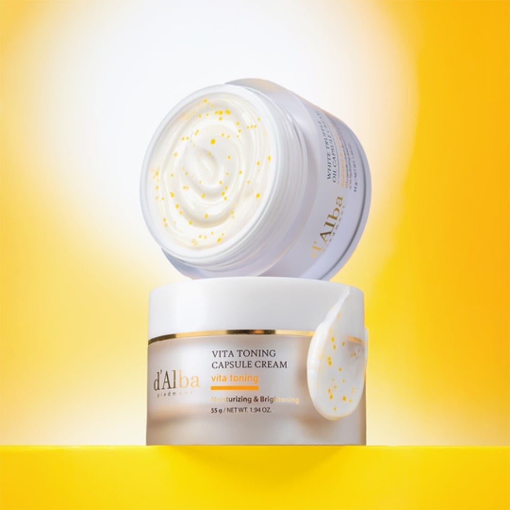D'ALBA Vita Toning Capsule Cream Complex 55g in open container showcasing rich cream texture against a bright yellow background.