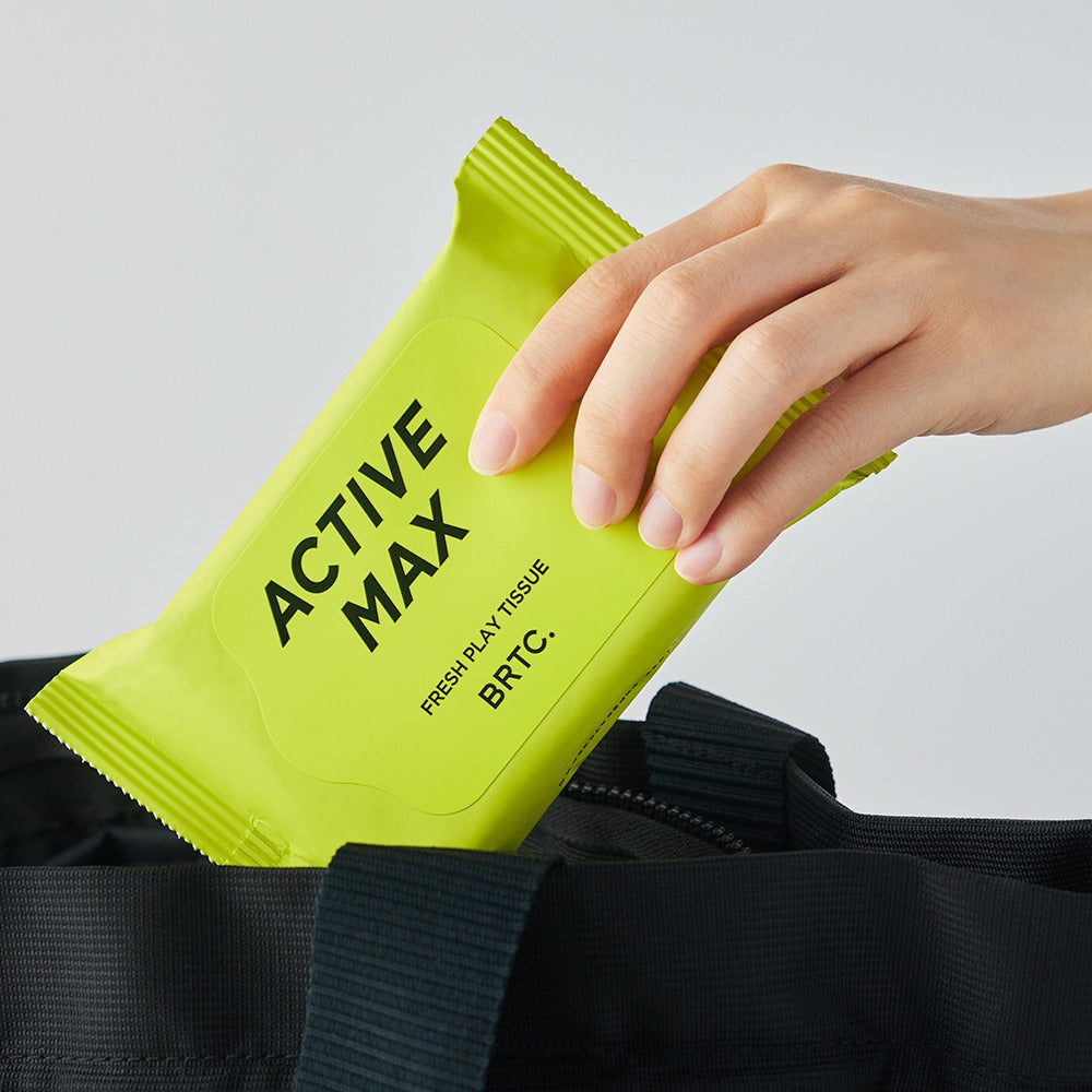 Gentleman Korea product image showing a hand placing BRTC Homme Active Max Fresh Play Tissue 15 Sheets into a bag