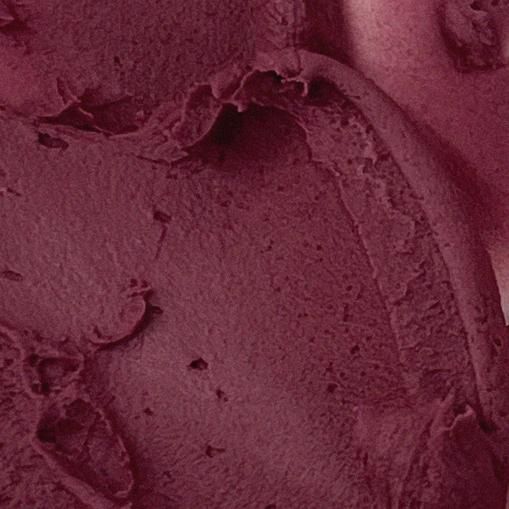 Close-up of AOU Floofy Matte Balm texture in rich burgundy shade.