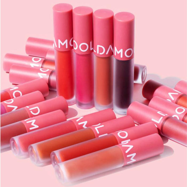 Assorted shades of MOOLDA Glow Dewy Tint displayed on a pink background.