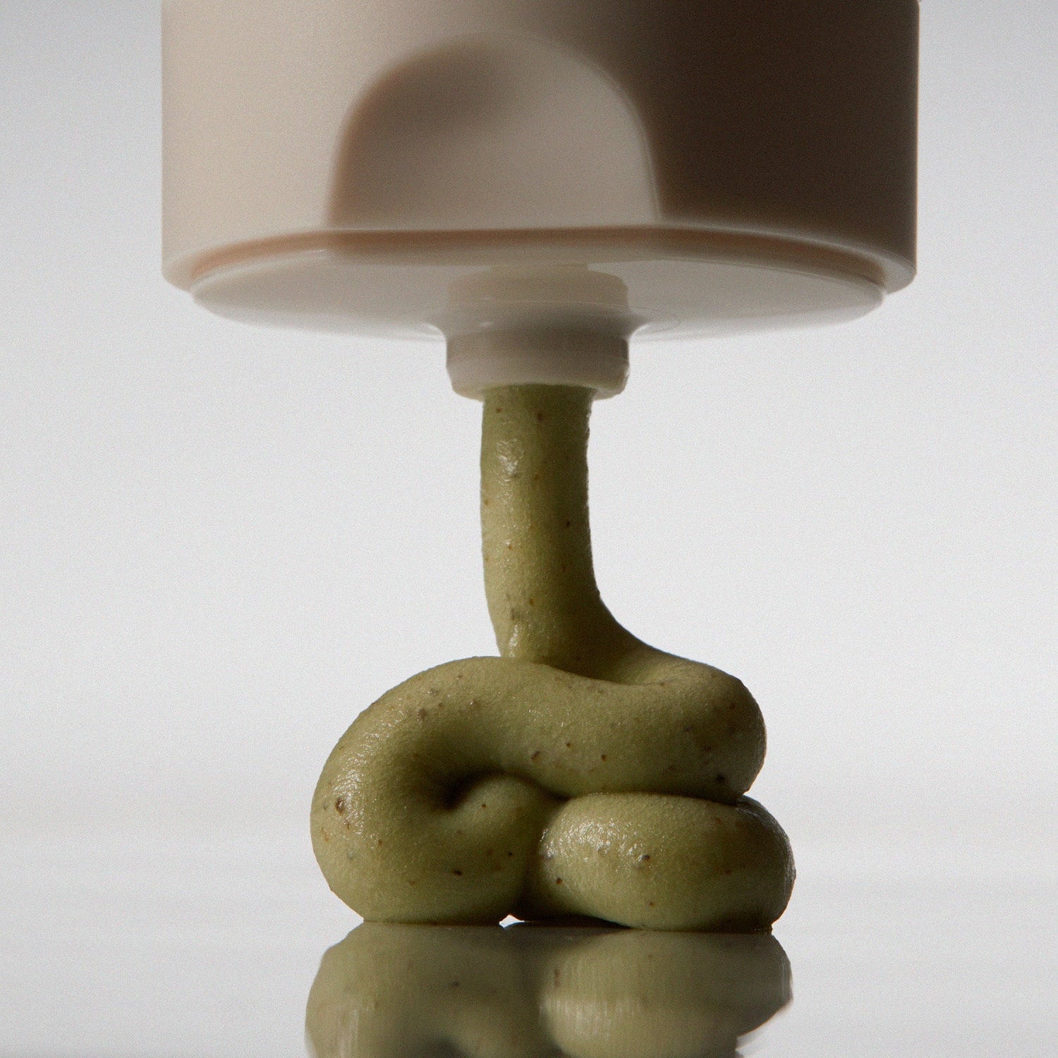 Close-up of AROMATICA Vitalizing Rosemary Pore Clearing Foam 150ML being dispensed, showcasing texture and color of the skincare product.