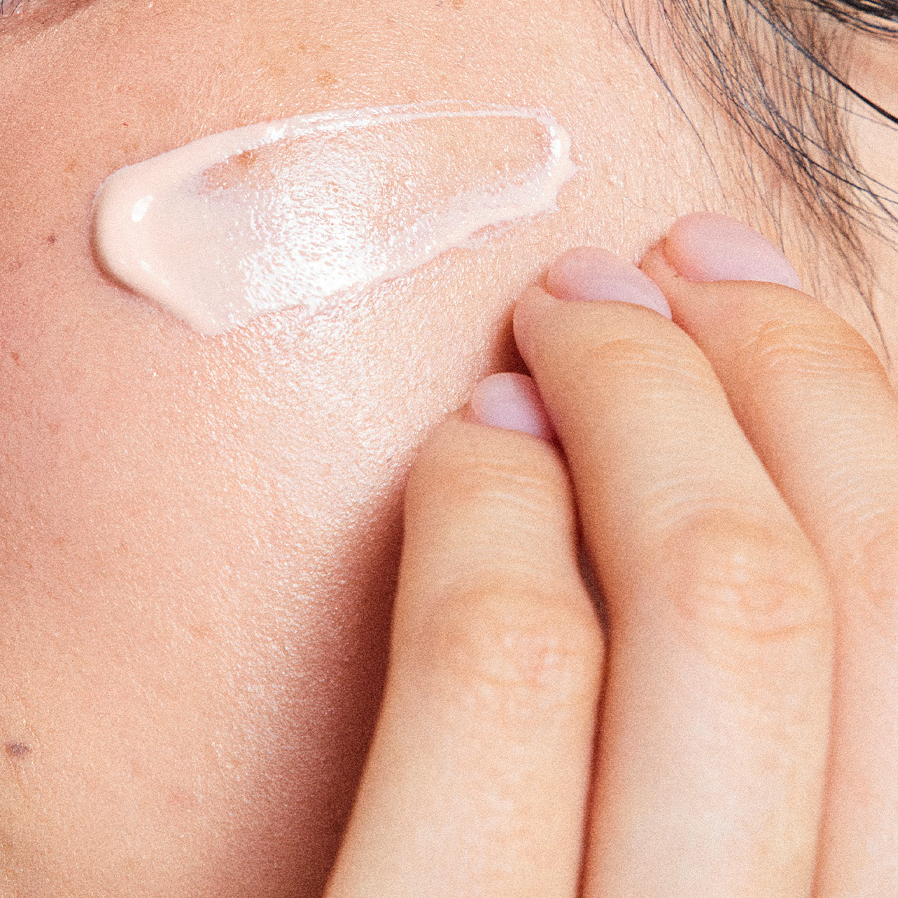 Applying LADOR Tamanu Tone Up Sunscreen 50ml on skin for sun protection and tone enhancement.