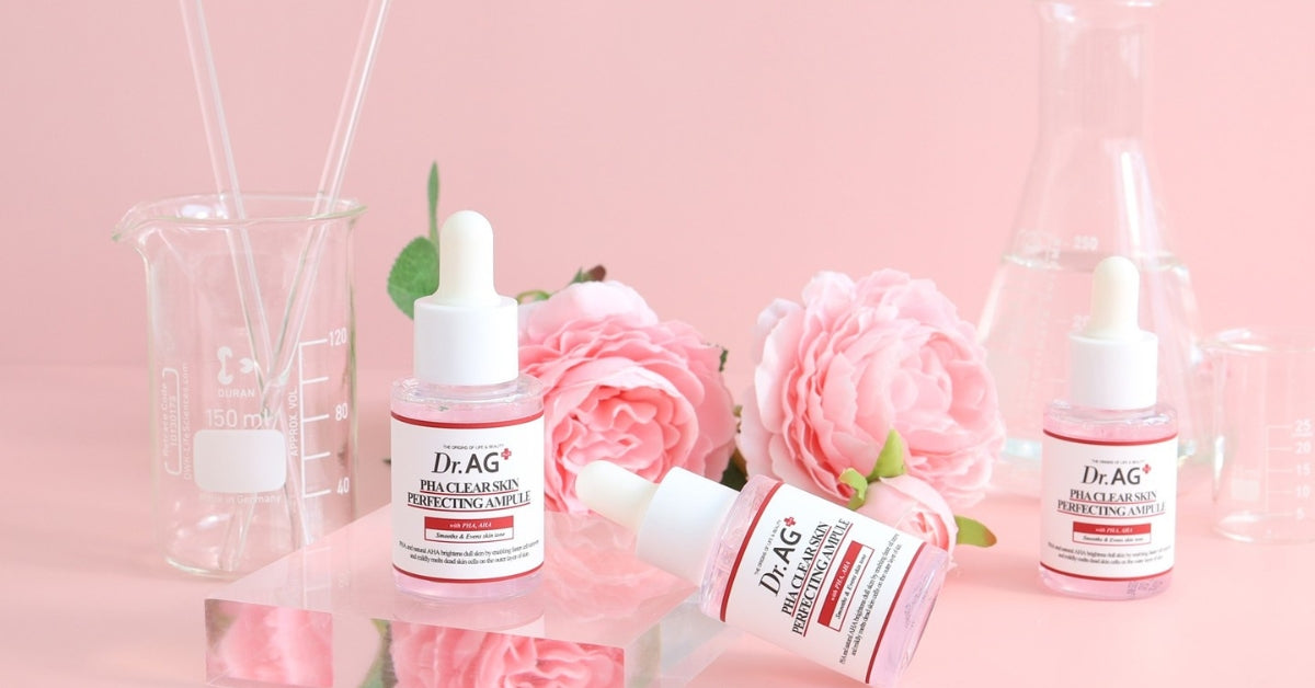 Discover Dr. AG: The Ultimate K-Beauty Experience with skincare serums and pink roses on a pink background