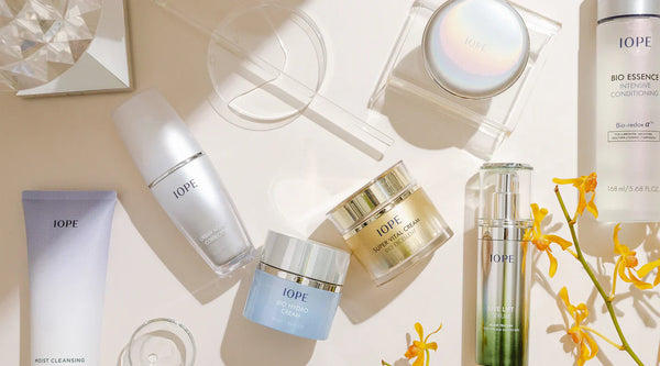 Unlocking the Secrets of IOPE: The Pioneering Korean Skincare Brand collection of IOPE products on a light background with flowers