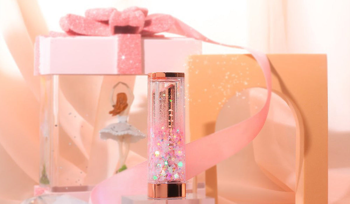 Exploring CORINGCO: The Korean Cosmetic Brand Redefining Beauty Standards - Shimmery lipstick tube with gift boxes and pink ribbon
