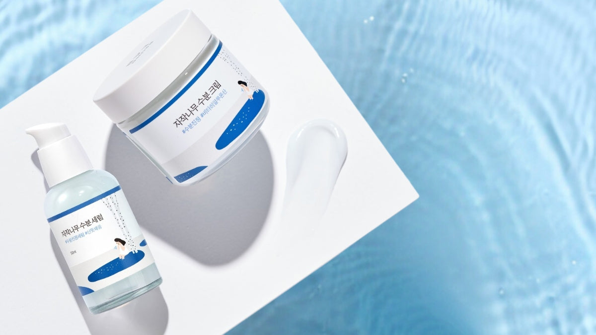 Round Lab skincare BFF products on a white surface and blue background, spotlighting nature's best ingredients for glowing skin.