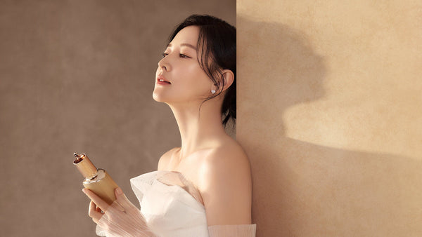 Woman holding THE HISTORY OF WHOO product, embodying Unveiling Timeless Elegance: Exploring the Majestic History of THE HISTORY OF WHOO in Korean Beauty.