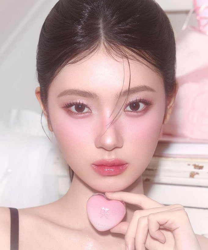 Person holding a pink DASIQUE Daisy Candy Rolling Pot showcasing the product's unique design and color in a close-up view.