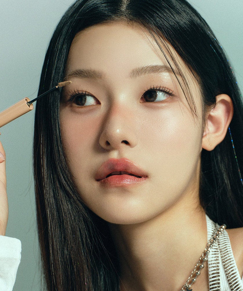 Woman applying HEART PERCENT Dot On Mood Fake Up Brow Cara to eyebrows; close-up view of product usage.