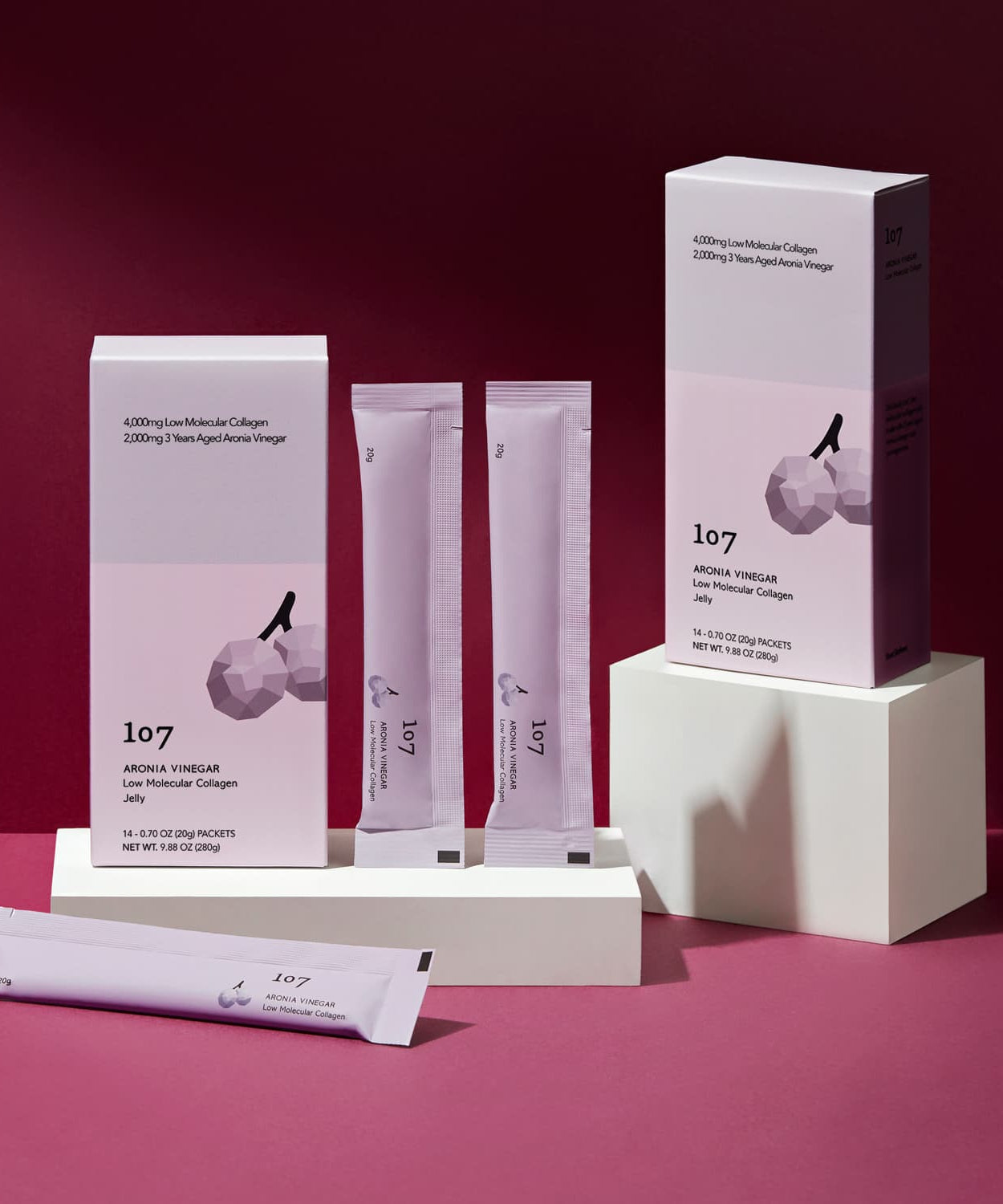 107 Aronia Vinegar Low Molecular Collagen 20g x 14 Packets displayed in elegant packaging on a rich burgundy background.