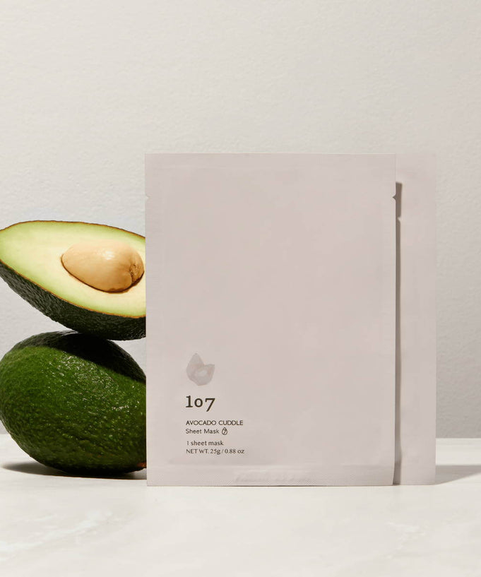 107 Avocado Curd Sheets Mask 5 Pieces with fresh avocados in background, ideal for nourishing skincare, moisturizing and hydrating face mask