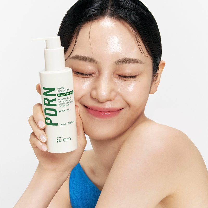 Woman holding a bottle of MAKE P:REM PDRN Pore Clay Cleansing Milk 500ml with a smile
