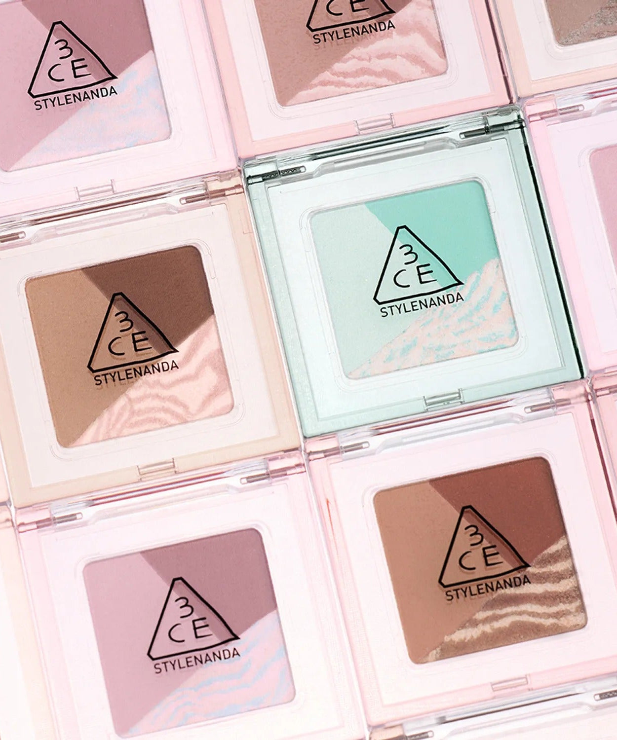 A collection of 3CE Color Grid Eyeshadow palettes showcasing various colors in stylish packaging.